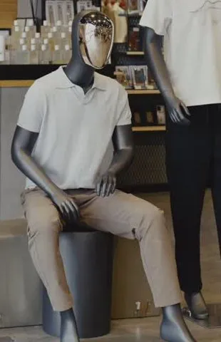 Close view of the off-white short-sleeve polo worn with sand chinos