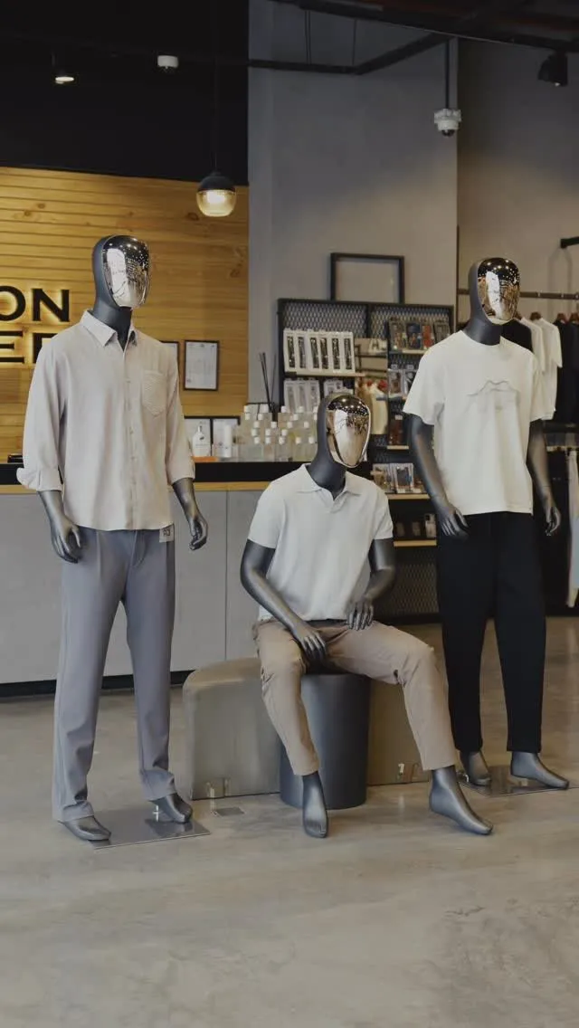 Three mannequins in polo, linen shirt and tee in front of the Fashion Corner counter